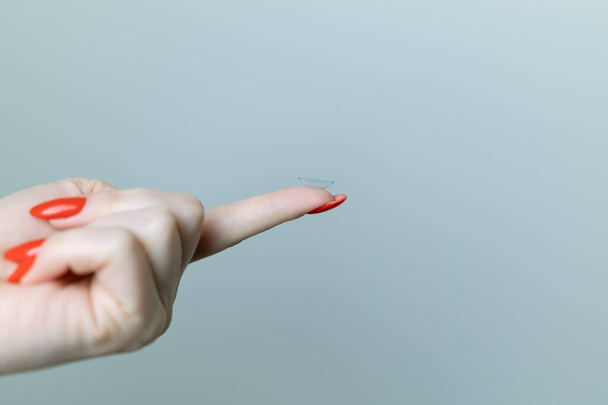 Contact lens on the finger of a female hand - Valokuva, kuva