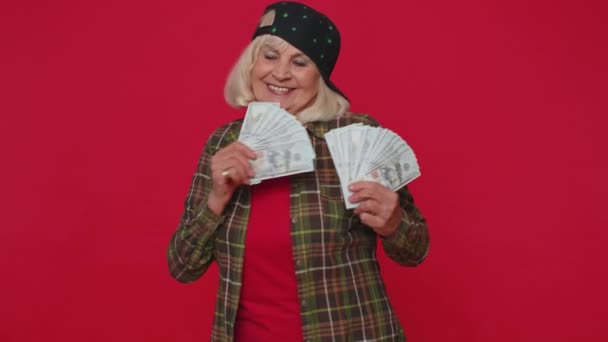 Rich pleased boss senior woman waving money dollar cash banknotes like a fan success business career - Felvétel, videó