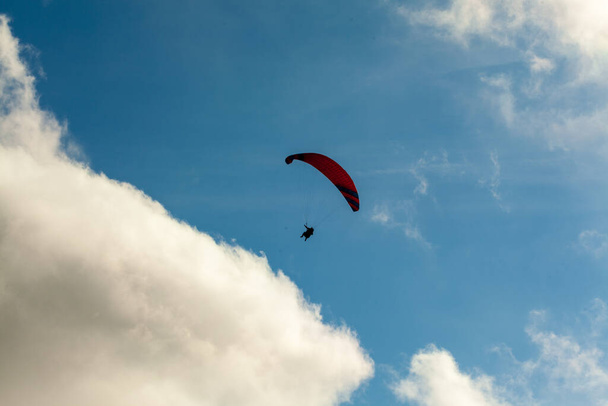 Parapente volando sobre las nubes en el día de verano
 - Foto, Imagen