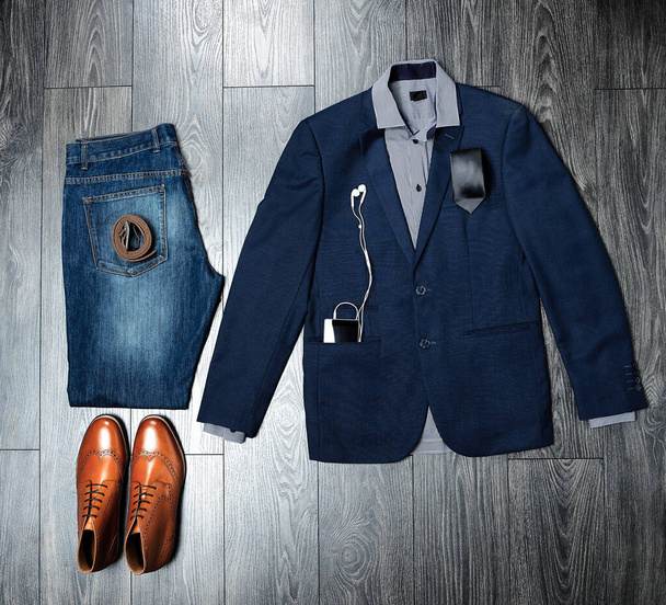 For the modern businessman. High angle shot of a casual work outfit on a wooden outfit. - Foto, afbeelding