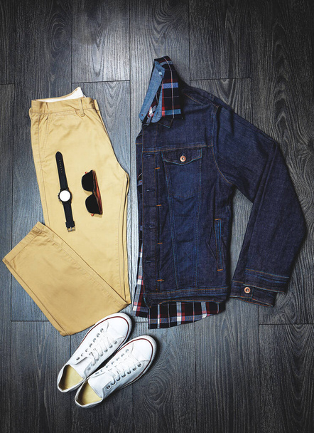 Accessories to match the outfit. High angle shot of a casual outfit on a wooden outfit. - Foto, imagen
