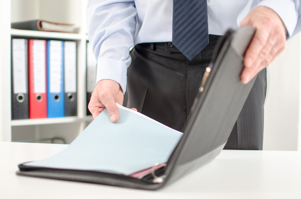 Businessman taking folder from his briefcase - Photo, Image