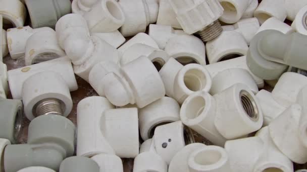 Many White Pvc Water Supply Pipe Fittings Close Up Footage. - Materiaali, video
