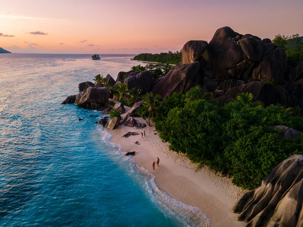 Anse Source dArgent beach, La Digue Island, Seyshelles, Drone aerial view of La Digue Seychelles bird eye view, couple men and woman walking at the beach during sunset at a luxury vacation - Foto, immagini
