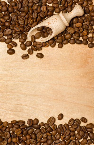 coffee seeds with wooden shovel on wood background - Photo, Image
