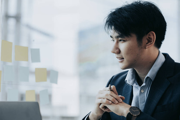 Asian man with suit, young businessman as startup company CEO, executive room, young startup company executives, run by young leaders. Management concept of startup companies and business men. - Photo, image
