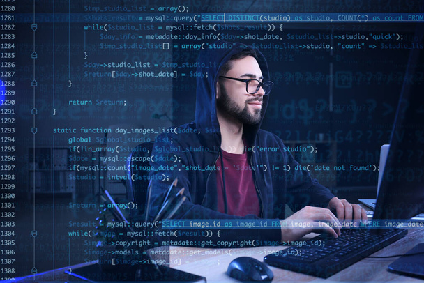 Double exposure of male programmer at workplace and computer code - Fotó, kép