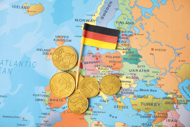 Flag of Germany and coins on Europe map - Foto, Imagem