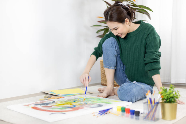Female artist painting on canvas, Artist studio interior, Draw with watercolor, Drawing supplies , Painting and creativity, Use a brush to draw a pattern by stripes, Artwork, Using Paint Brush. - Photo, Image
