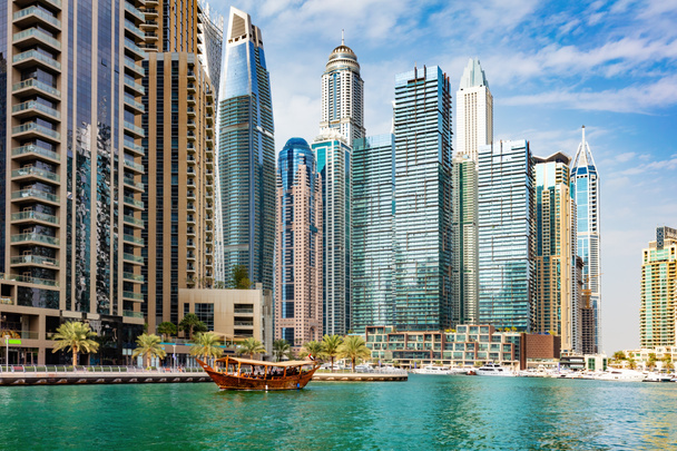 Dubai marina and tourist traditional boat in UAE. High-rise residential buildings, business skyscrapers - 写真・画像