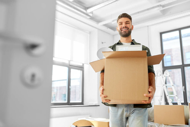 happy man with box moving to new home - Φωτογραφία, εικόνα
