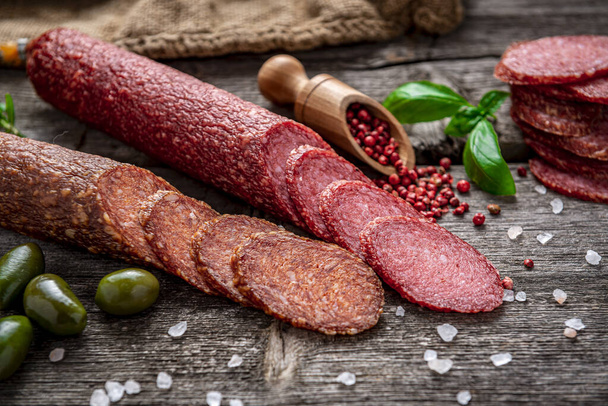 Best quality italian salami on old wooden table. Salami. Dried organic salami sausage or spanish chorizo - Foto, Imagen