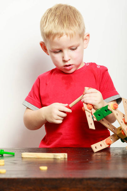 Childhood, kids imagination concept. Concentrated little boy playing with toys having fun - 写真・画像