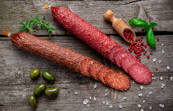 Best quality italian salami on old wooden table. Salami. Dried organic salami sausage or spanish chorizo - Photo, Image