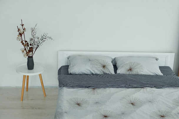 Grey bed. Interior and design of beautiful modern bedroom at daytime. - 写真・画像
