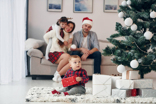 Beautiful family celebrates New year and christmas indoors at home. - Фото, изображение