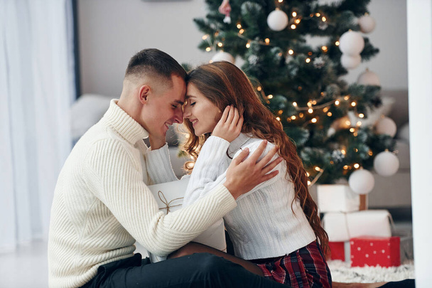 Closeness of the people. Young romantic couple celebrates New year together indoors. - Zdjęcie, obraz