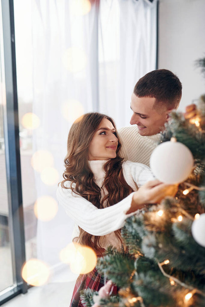 Young romantic couple celebrates New year together indoors. - Foto, imagen