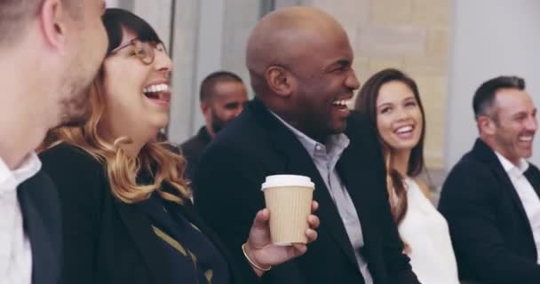 Hold on to your coffee because this is going to be funny. 4k video footage of a group of businesspeople laughing during a conference. - Video
