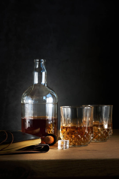 a bottle of cognac with two glasses - Фото, изображение