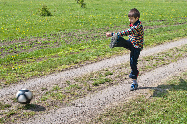Boy beats kick a soccer ball - Фото, изображение