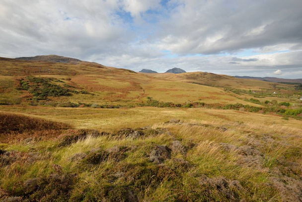 Mountain peaks, valleys and hills of Jura island. Panoramic view. Dramatic sky. Scotland, UK. Atmospheric landscape. Travel destinations, landmarks, hiking, ecotourism, environmental conservation - Zdjęcie, obraz