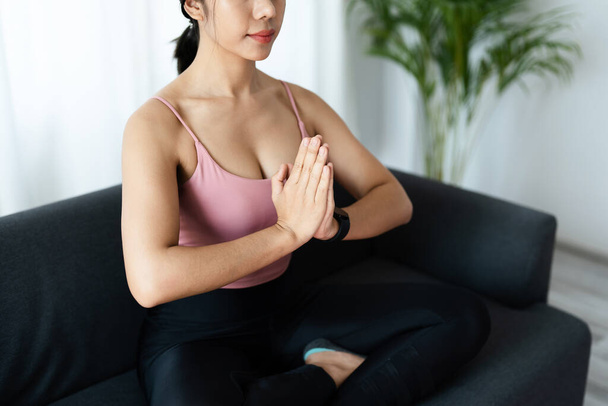 stress relief, muscle relaxation, breathing exercises, exercise, meditation, portrait of Young Asian woman relaxing her body from office work by practicing yoga by watching online tutorials. - Φωτογραφία, εικόνα