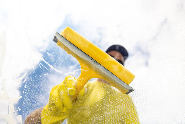 cleaning window with squeegee. Cleaning conept image. - Photo, Image