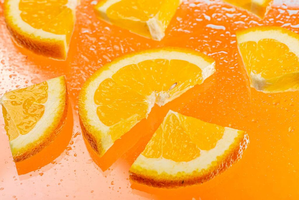 Sliced pieces of fresh orange with water drops - Fotó, kép