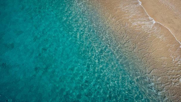 Aerial view of beautiful sandy beach and soft turquoise ocean wave. Tropical sea in summer season on Egremni beach on Lefkada island. - Zdjęcie, obraz