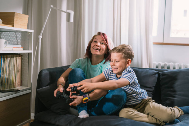 young caucasian mother and her son playing video games at home - Foto, immagini