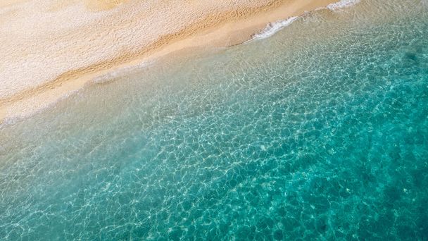 Aerial view of beautiful sandy beach and soft turquoise ocean wave. Tropical sea in summer season on Egremni beach on Lefkada island. - Photo, image