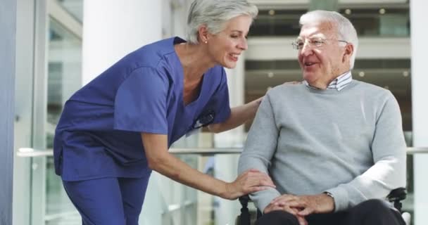 How are you feeling. 4k video footage of a mature female nurse talking to a wheelchair-bound senior male patient. - Filmati, video