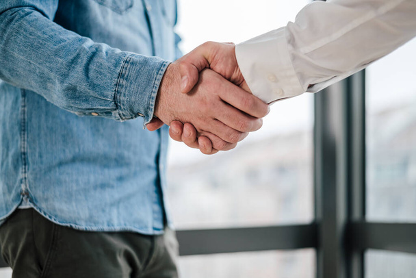 Close up shot of teamwork handshake in the office businessman entrepreneur freelancer shaking hands for successful negotiations and company business merger and acquisition - Photo, Image