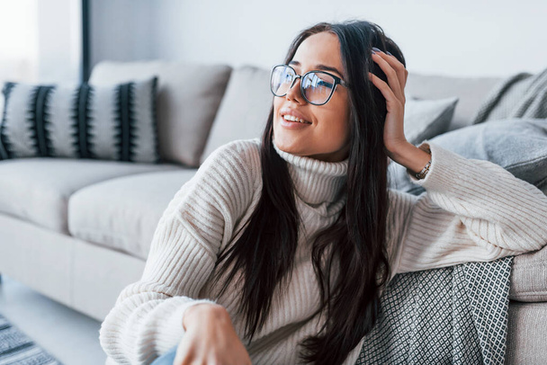 Young beautiful woman in glasses sitting at home alone. - Foto, imagen