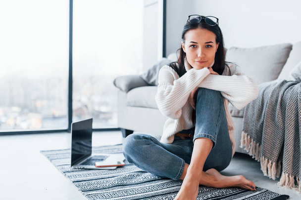 Young beautiful woman in casual clothes sitting at home alone. - Fotoğraf, Görsel