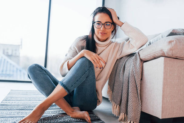 Young beautiful woman in casual clothes and in glasses sitting at home alone. - Foto, Imagem
