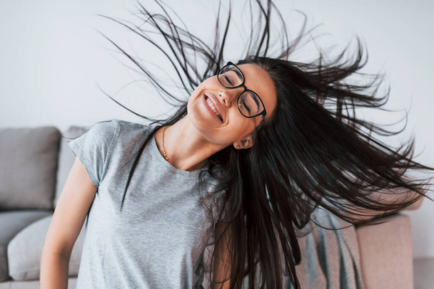 Young beautiful woman in casual clothes and glasses have fun at home alone. - Fotoğraf, Görsel