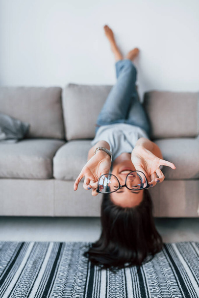 Young beautiful woman in casual clothes lying down on the bed and have fun at home alone. - Fotoğraf, Görsel