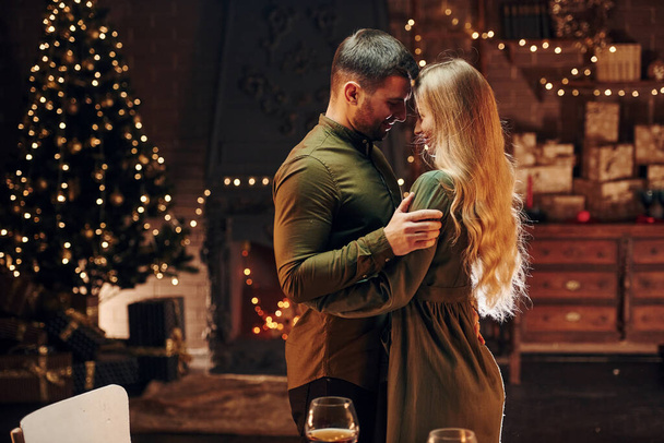 Standing and dancing. Young lovely couple have romantic dinner indoors together. - Valokuva, kuva