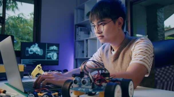 Asian teenager doing Arduino robot homework project in house, technology of robotics programing and kids education concept. - Materiał filmowy, wideo