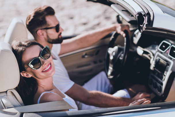 Photo of pretty excited boyfriend girlfriend dressed casual outfit enjoy sunshine driving cabriolet outdoors countryside - Фото, изображение