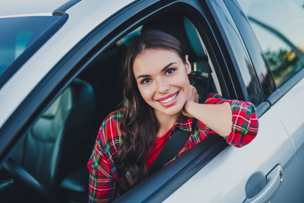 Portrait of attractive cheerful wavy-haired girl driving car enjoying good mood rest vacation trip tour outdoors - Foto, immagini