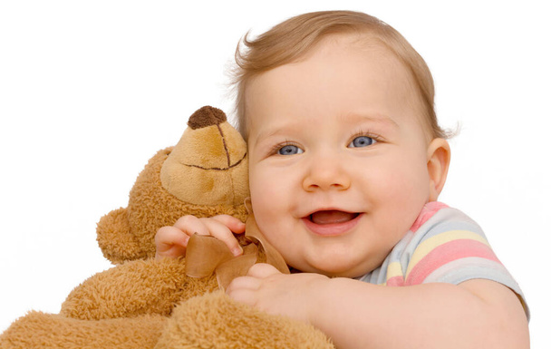 Toddler cuddles the furry teddy bear - Fotografie, Obrázek