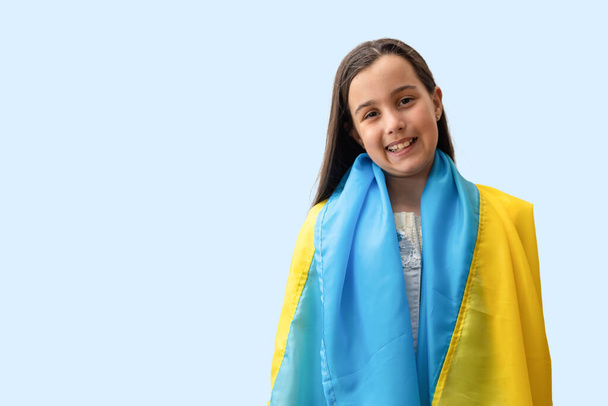 little girl flag of ukraine. Pray for Ukraine. Save Ukraine. The children are asking for peace. There is no war. - Zdjęcie, obraz