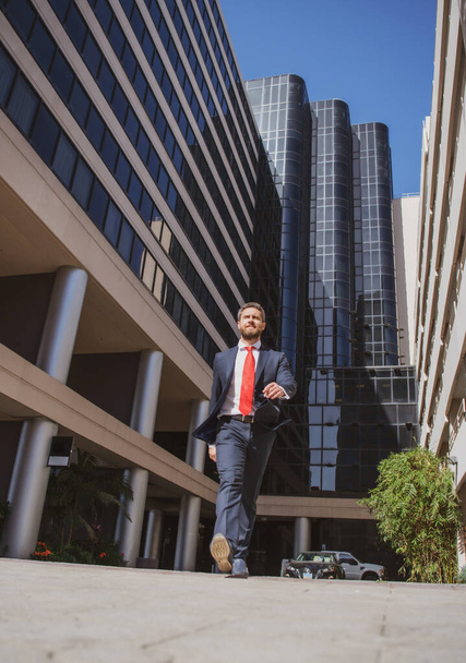 Businessman walking on the street. Business man walk near modern business center. Business and architecture concept. Business success, step, boost personal career, and winning. - Foto, Bild