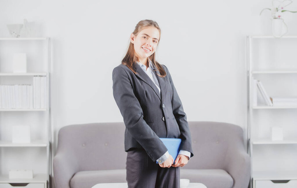 Young business woman freelancer or ceo employee holding notebook working in office. - Foto, immagini