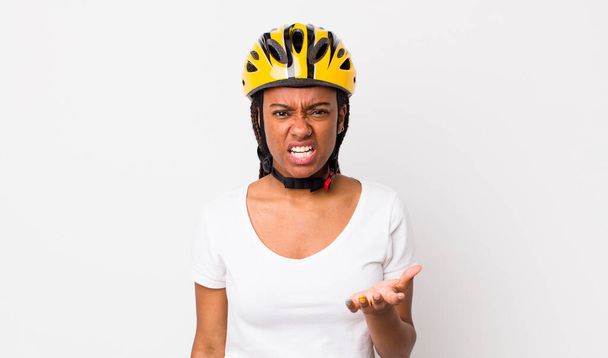 pretty afro woman with braids with a bike helmet - Photo, image