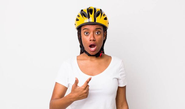 pretty afro woman with braids with a bike helmet - Foto, Imagen