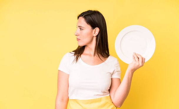 young adult pretty woman home chef with empty plate - Foto, Imagen